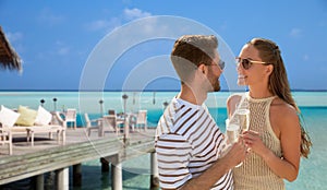 happy couple with champagne over beach restaurant