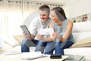 Happy couple checking bank account online