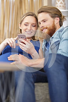 happy couple checking phone together