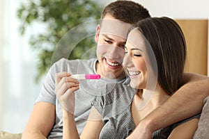 Happy couple checking pregnancy test photo