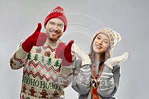 Happy couple at christmas ugly sweater party