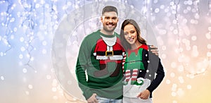 Happy couple at christmas ugly sweater party