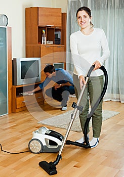 Happy couple cleaning in home