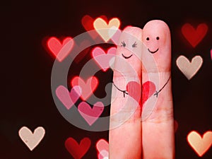 Happy Couple Concept. Two fingers in love with painted smiley