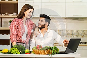 Happy Couple Cook with Laptop