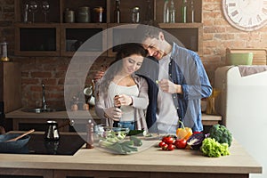 Happy couple cooking healthy food together