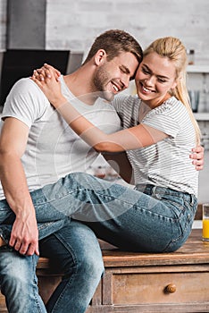 happy couple cuddling and sitting photo