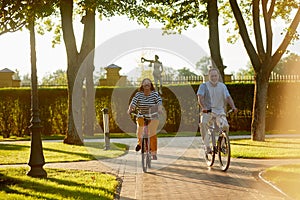 Happy couple cycling in the park.