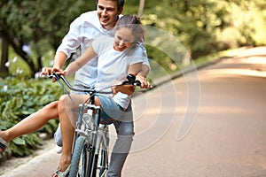 Happy Couple Cycling in the Summer Park