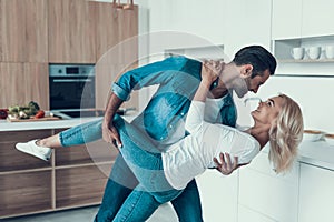 Happy couple dancing in kitchen. Romantic relationship.