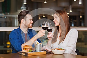 Happy couple dining and drink wine at restaurant