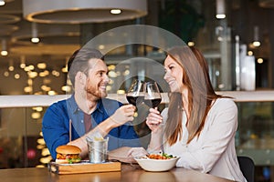 Happy couple dining and drink wine at restaurant