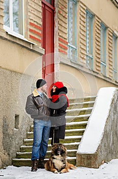 Happy couple with dogs in winter forest. Lovely moments outdoor