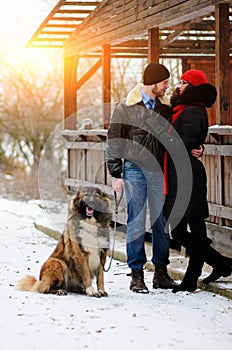 Happy couple with dogs in winter forest. Lovely moments outdoor