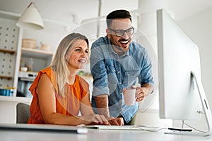 Happy couple doing business together working at small office