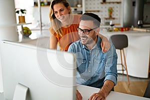 Happy couple doing business together working at small office