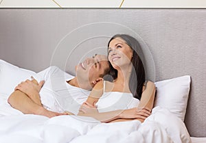 Happy couple dreaming in bed