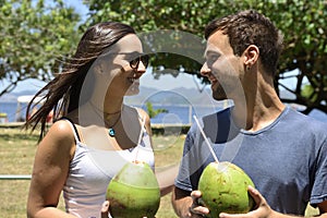 Happy couple drinking coconut water