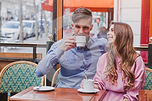 Happy couple drinking coffee in cafe