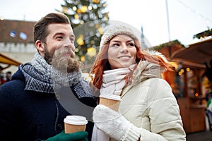 Happy couple drinking coffee on old town street