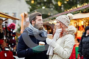 Happy couple drinking coffee on old town street