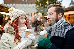 Happy couple drinking coffee on old town street