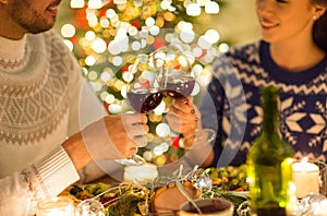 Happy couple drinking red wine at christmas dinner