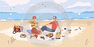 Happy couple drinking wine and eating at seaside. Young man and woman spending time together at picnic on sandy beach