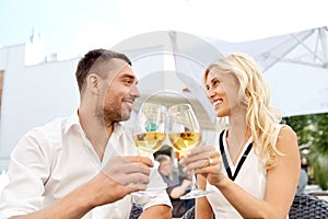 Happy couple drinking wine at open-air restaurant