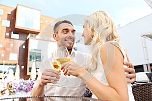 Happy couple drinking wine at open-air restaurant