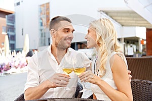Happy couple drinking wine at open-air restaurant