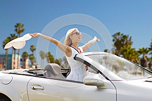 Happy couple driving in convertible car