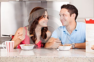 Happy couple eating cereal