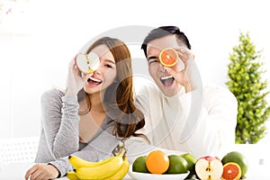 Happy couple eating fruit and healthy food