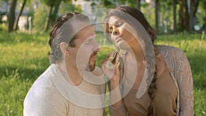 Happy couple eating sanwich together