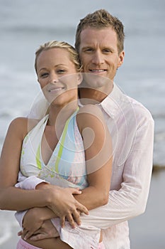 Happy Couple Embracing At Beach