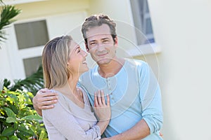 Happy couple embracing in the yard