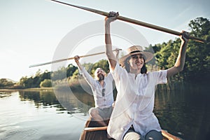 Happy couple enjoy canoe ride on the lake