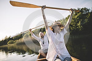 Happy couple enjoy canoe ride on the lake