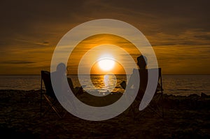 Happy couple enjoy luxury sunset on the beach during summer vacations