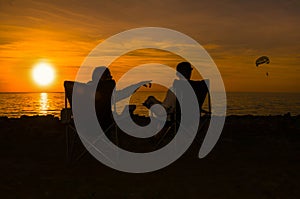 Happy couple enjoy luxury sunset on the beach during summer vacations