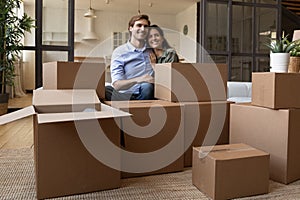 Happy couple enjoy moving to new home together