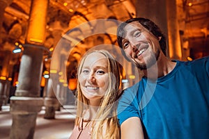 Happy couple enjoying Beautiful cistern in Istanbul. Cistern - underground water reservoir build in 6th century
