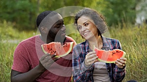 Happy couple enjoying big slices of yummy watermelon, beneficial fruit diet