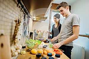 Happy couple enjoying cooking time together at home kitchen.Enjoying simple moments at home.Making vegan dishes.Plant based diet.