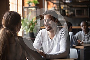 Happy couple enjoying date in cafe drinking coffee