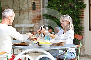 Happy couple enjoying lunch on terrace