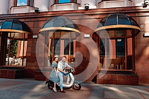 Happy couple enjoying a scooter ride in the city