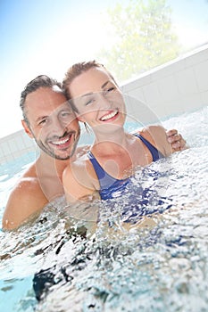 Happy couple enjoying in spa center
