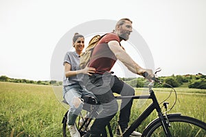 Happy couple enjoying in their love and bicycle riding